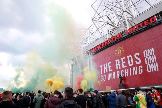 Fans let off flares as they protest against the Glazer family, owners of Manchester United