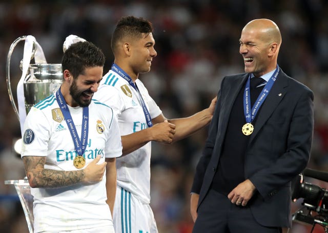 Real Madrid head coach Zinedine Zidane shares a joke with Alarcon Isco and Carlos Casemiro during the UEFA Champions League final