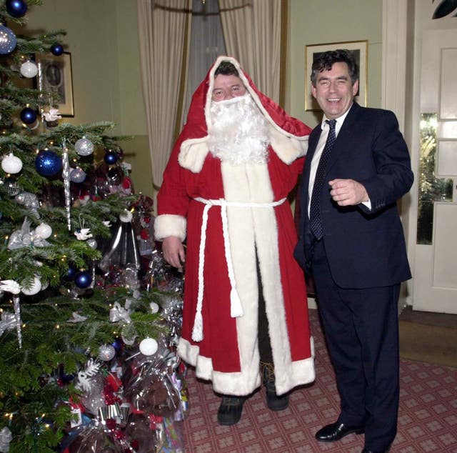 Then chancellor Gordon Brown poses with actor Robbie Coltrane dressed as Father Christmas at a Christmas party at No 11 Downing Street, London, on December 3 2001.