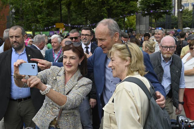Taoiseach Micheál Martin poses for a photo at Fleadh Cheoil na hÉireann 2026 in Belfast