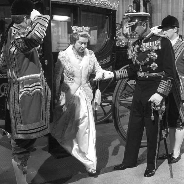 The Duke of Edinburgh helping the Queen off the Australia State Coach as the pair arrive at the Houses of Parliament for the State Opening in November 1988