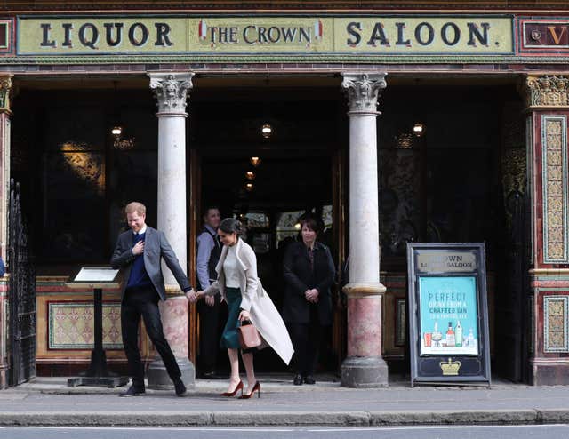 Harry and Meghan leaving the Crown Liquor Saloon where they sat down to a traditional Irish pub lunch (Gareth Fuller/PA)