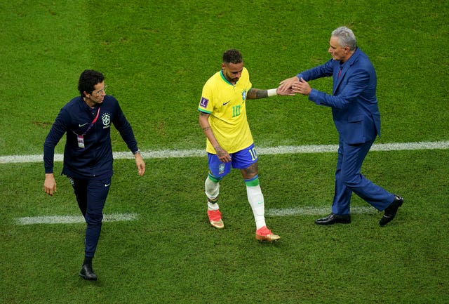 Brazil boss Tite (right) consoles Neymar as the forward comes off (Mike Egerton/PA).