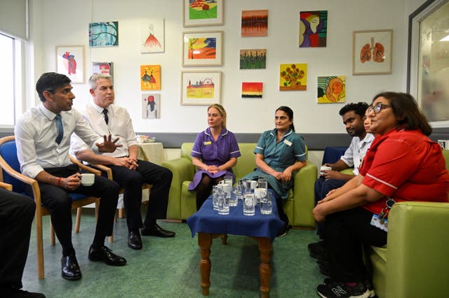 Rishi Sunak speaks with staff during a visit to St George’s hospital in London 