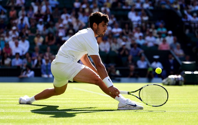 Carlos Alcaraz slides into a forehand