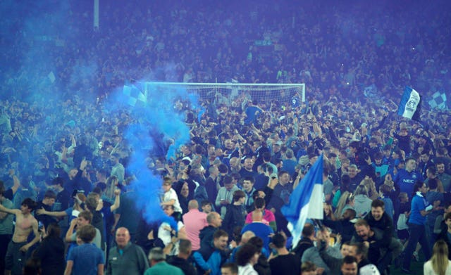 Everton fans celebrate on the pitch after the Premier League match at Goodison Park, Liverpool. Picture date: Thursday May 19, 2022