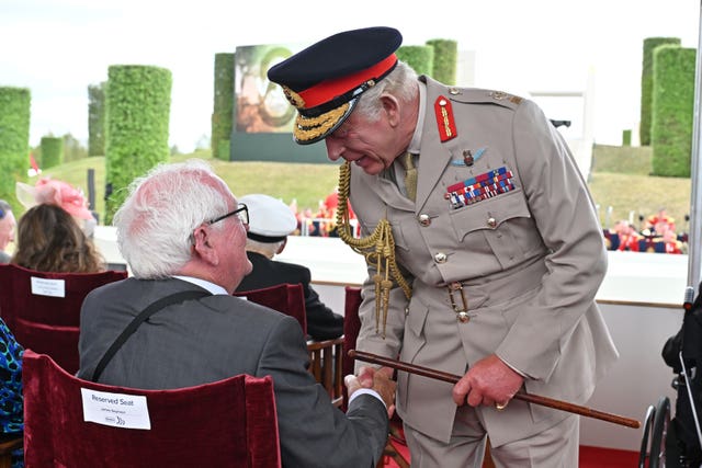 The King speaks to James Seymour during the national Service of Remembrance marking the 80th Anniversary of VJ Day at the National Memorial Arboretum