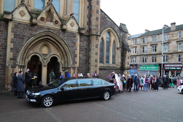 A hearse outside a church  