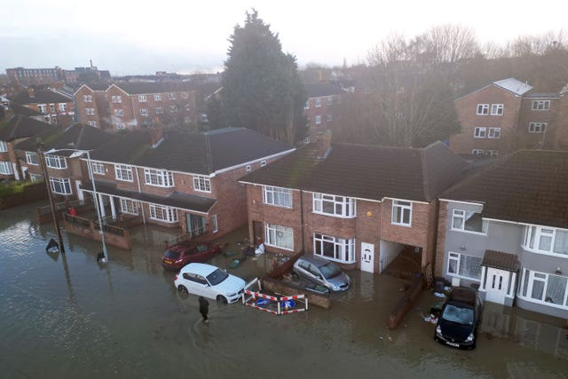 A person walks down a flooded street in Loughborough