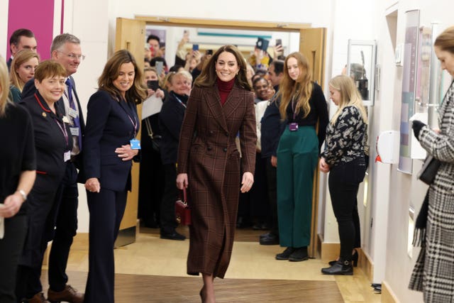 Kate walking through the hospital where she was treated watched by staff and visitors