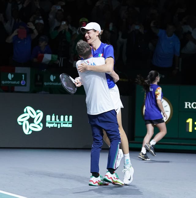 Jannik Sinner is hugged by captain Filippo Volandri