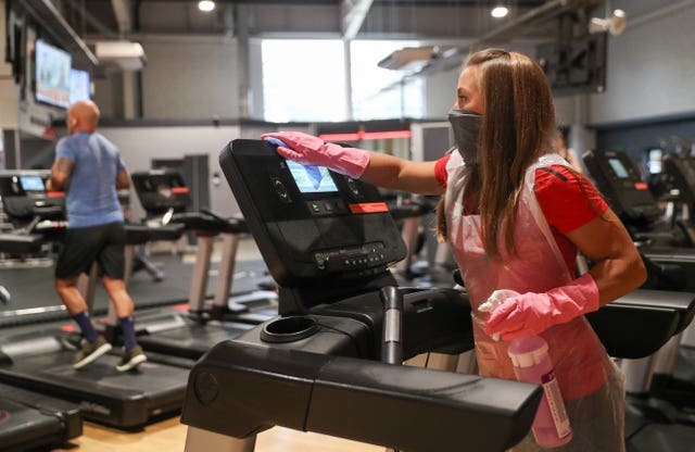 General manager Tori Waight cleans a treadmill at DW Fitness First in Basingstoke