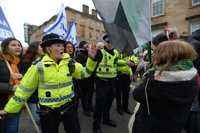 Police intervene as pro-Palestinian and pro-Israeli demonstrators face-off during the anti-racism rally in Glasgow (Mark Runnacles/PA)