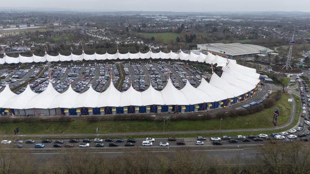 Vehicles queue for the car parks at the Ashford Designer Outlet, in Kent, during the Boxing Day sales