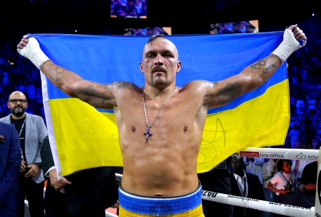 Oleksandr Usyk celebrates after winning 