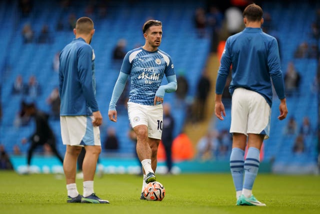 Jack Grealish, centre, warms up with Manchester City