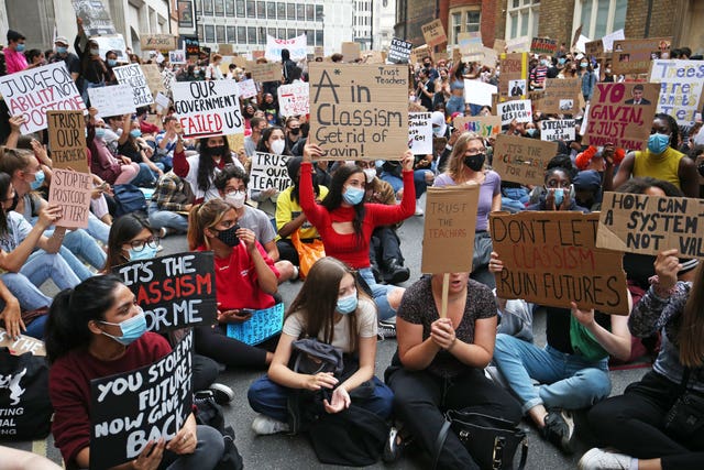 People take part in a protest outside the Department for Education, London, in response to the downgrading of A-level results