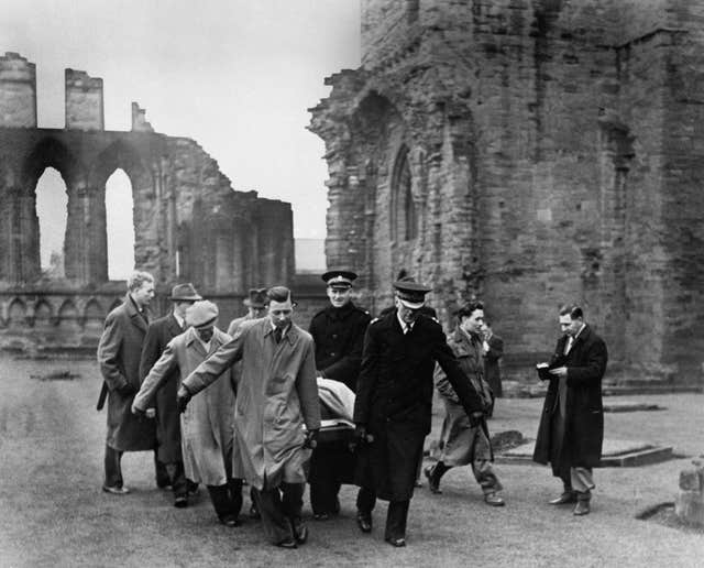 Group of men carrying the Stone of Destiny away from Arbroath Abbey