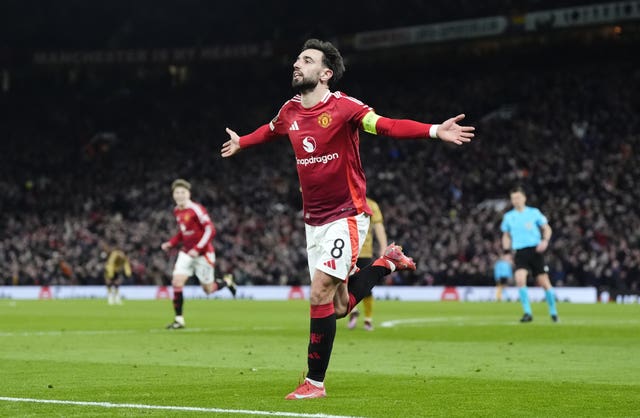 Manchester United captain Bruno Fernandes runs with his arms outstretched after scoring