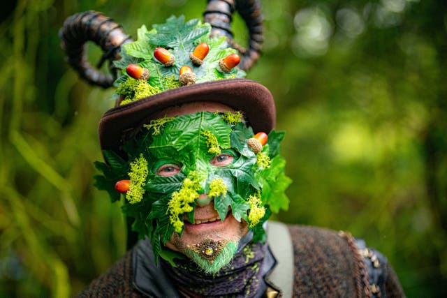 A green man observes a modern interpretation of the ancient Celtic pagan fertility rite of spring