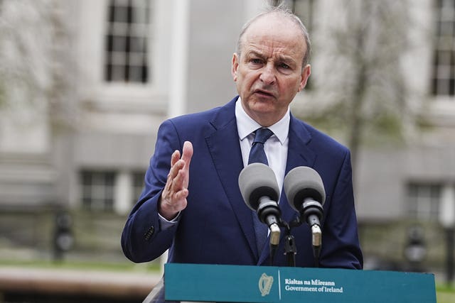 Micheal Martin gesturing with one hand while speaking from a lectern outside