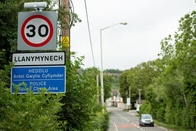 A sign on entering Llanymynech, where the border for England and Wales runs along the pictured A483 (Jacob King/PA)