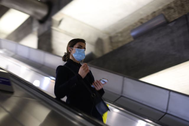 A woman at Westminster Underground Station in London wearing a face covering (James Manning/PA)