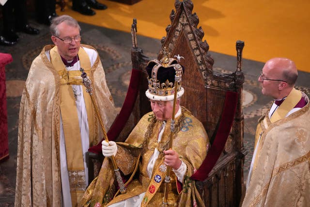 The King, head of the Church of England, after being crowned with St Edward’s Crown in May 2023