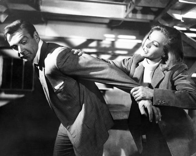 Honor Blackman puts Sean Connery in an arm lock during a scene for Goldfinger at Pinewood Studios in Buckinghamshire (PA Archive)