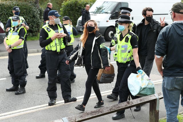 One protester is led away by police outside the Newsprinters printing works at Broxbourne, Hertfordshire