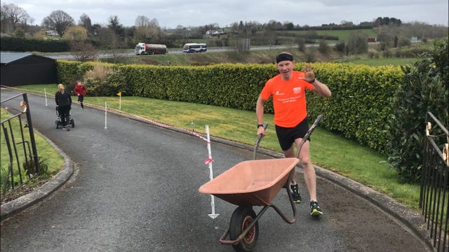 Keith Clarke during his attempt to complete a full marathon in his driveway while pushing a wheelbarrow, to raise money for the NHS