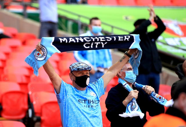 A Manchester City fan in the stands at Wembley 