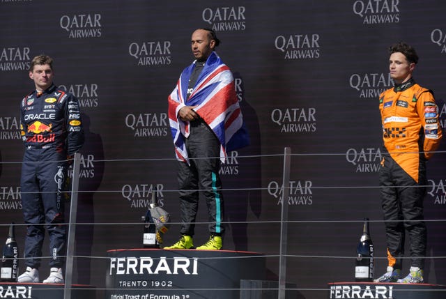 British Grand Prix winner Lewis Hamilton on the podium with Max Verstappen and Lando Norris either side of him