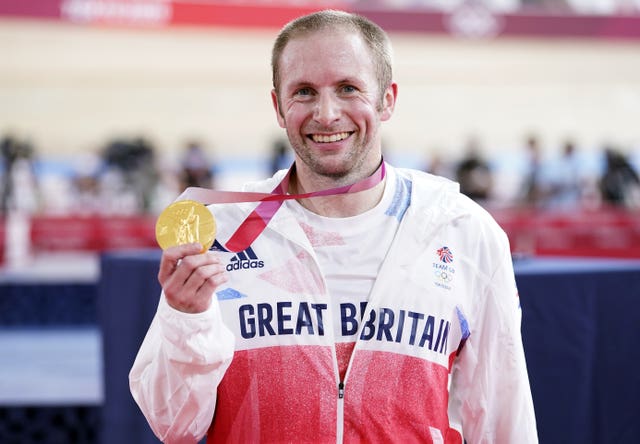 Great Britain cyclist Jason Kenny holds up his Keirin gold medal