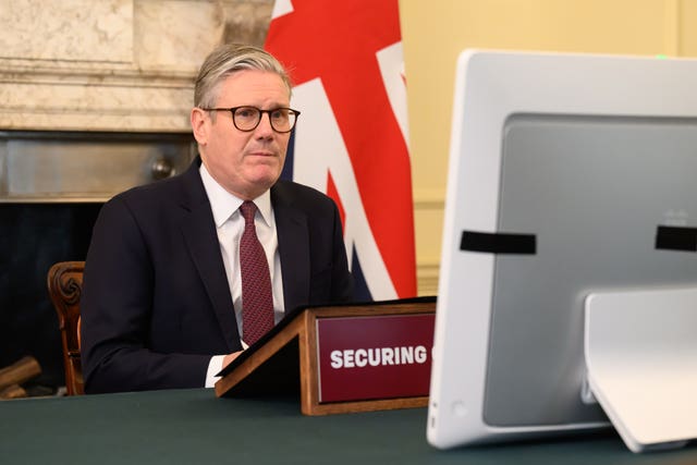 Sir Keir Starmer in front of a computer