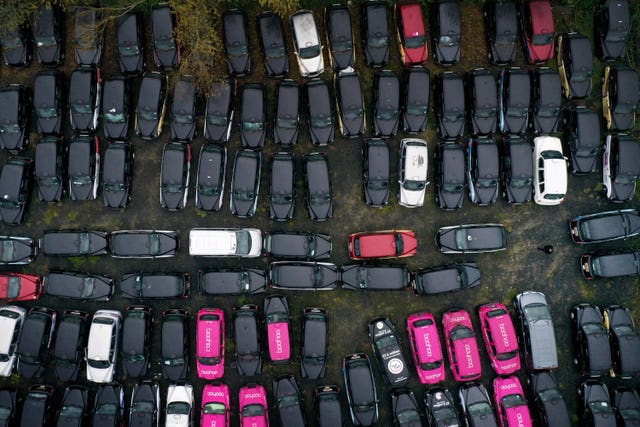 More than 200 unused black cabs parked in a large area of farmland