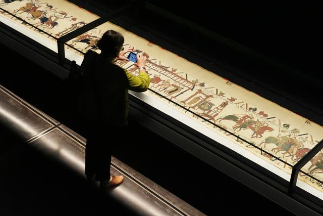 A person views the Bayeux Tapestry at the British Museum in London