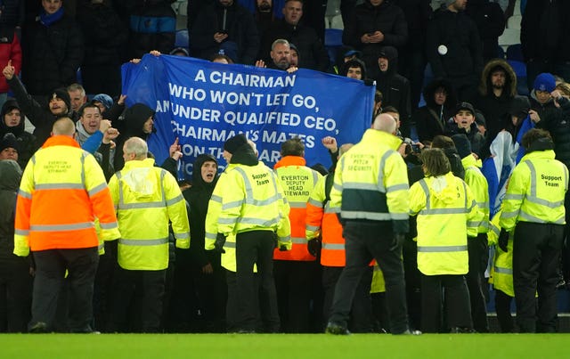 Everton fans hold up banners in protest against the club's board 