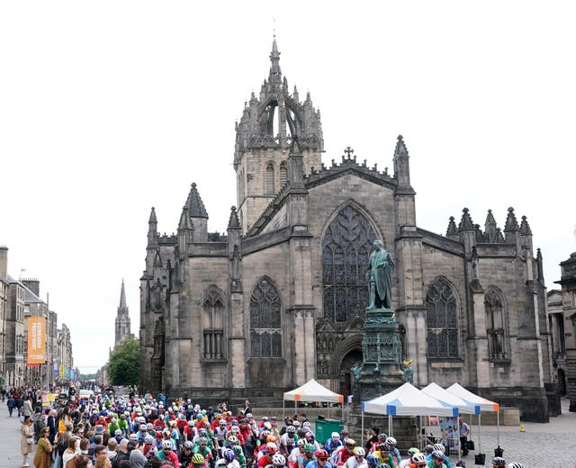 Cyclists travel past St Giles Catherdral in Edinburgh in 2023