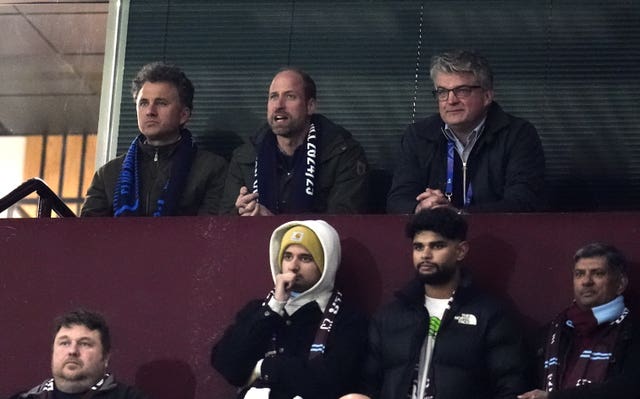 Prince William (back centre) watches an Aston Villa match