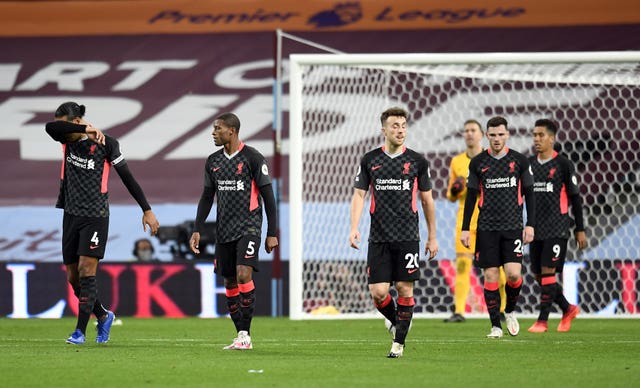 Liverpool's players appear dejected after Aston Villa score their fourth goal on Sunday