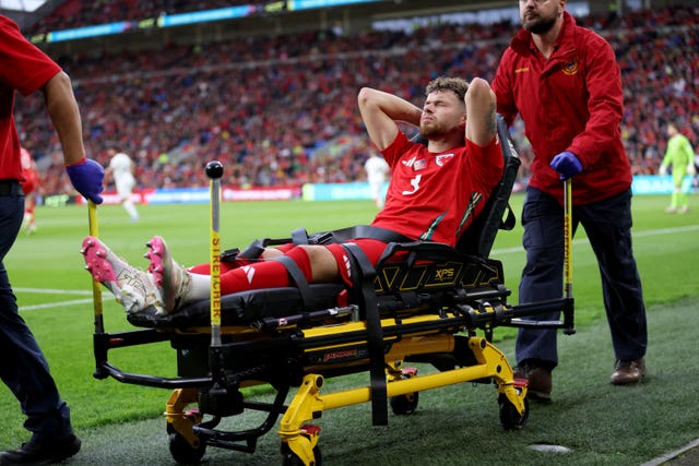 Wales’ Neco Williams is stretchered off