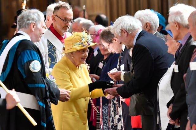 The Queen distributing Maundy money during the Royal Maundy Service at St George’s Chapel in Windsor