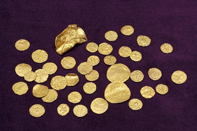 Gold coins, along with four other gold objects, unearthed by metal detectorists which is the largest hoard of Anglo-Saxon gold coins to be discovered in England to date