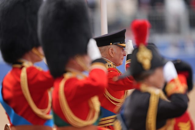The King salutes the regiments taking part in the Trooping the Colour ceremony