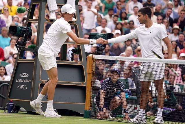 Jannik Sinner and Carlos Alcaraz shake hands at the net at Wimbledon