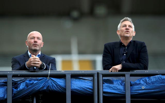 Alan Shearer, left, and Gary Lineker lean on a railing while watching a match at Newcastle