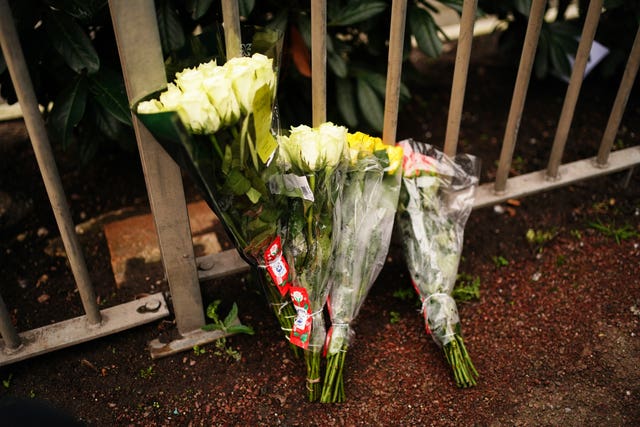 Floral tributes are left next to a bus stop on Woolwich Church Road in Woolwich, south London, after a 14-year-old boy was stabbed to death on a London Bus