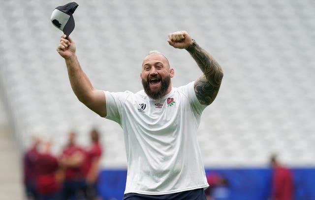 Joe Marler waves his arms and his cap during an England training session