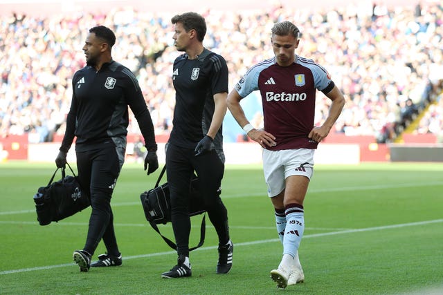 Aston Villa's Matty Cash, right, leaves the pitch injured against Arsenal